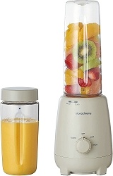 bottle blender juicer with fruits waiting to be juiced in a prepped tumbler